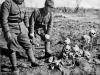 Japanese-Soldiers-Looking-at-a-Pile-of-Skulls-of-Chinese-Civilians-Killed-in-The-Outskirts-of-Shandong-China-1938.