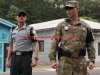 A U.S. soldier, right, and South Korean soldiers stand guard at the truce village of Panmunjom in the Demilitarized Zone (DMZ) in Paju, South Korea, on Thursday, July 27, 2017. South Korean President?Moon Jae-in?is seeking a deal with North Korea in 2020 to bring about the "complete denuclearization" of the isolated nation in return for a peace treaty that would guarantee the survival of?Kim Jong Un's regime. Photographer: SeongJoon Cho/Bloomberg via Getty Images