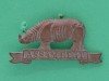 Cap badge, Assam Regiment, 1941-1947 Brass badge in the form of a rhinoceros over a scroll, with a unit tile, 'Assam Regt'.-40-x-20mm-1